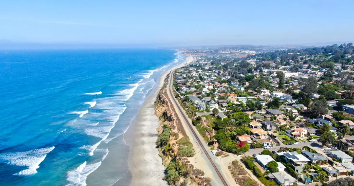 Technician servicing a residential air conditioner in Del Mar