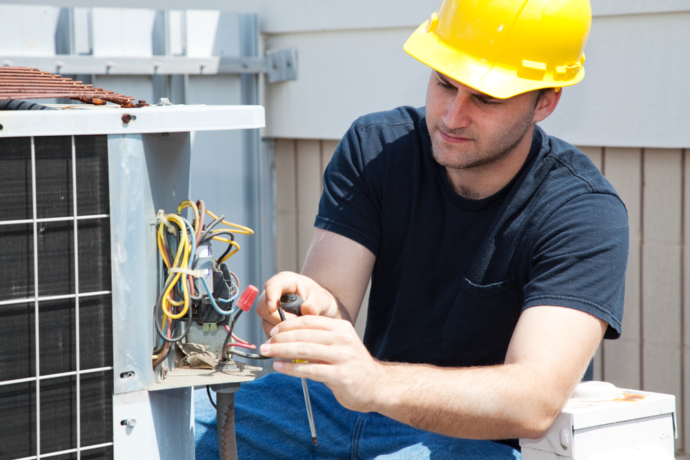 Technician servicing an air conditioner